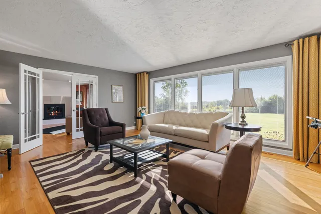 a living room with furniture and a floor to ceiling window