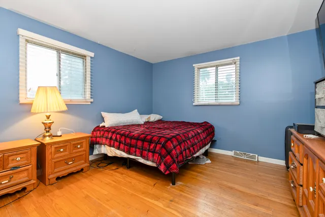 a bedroom with a bed dresser and a window