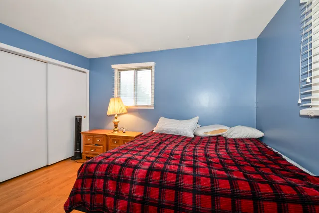 a bedroom with a bed and window