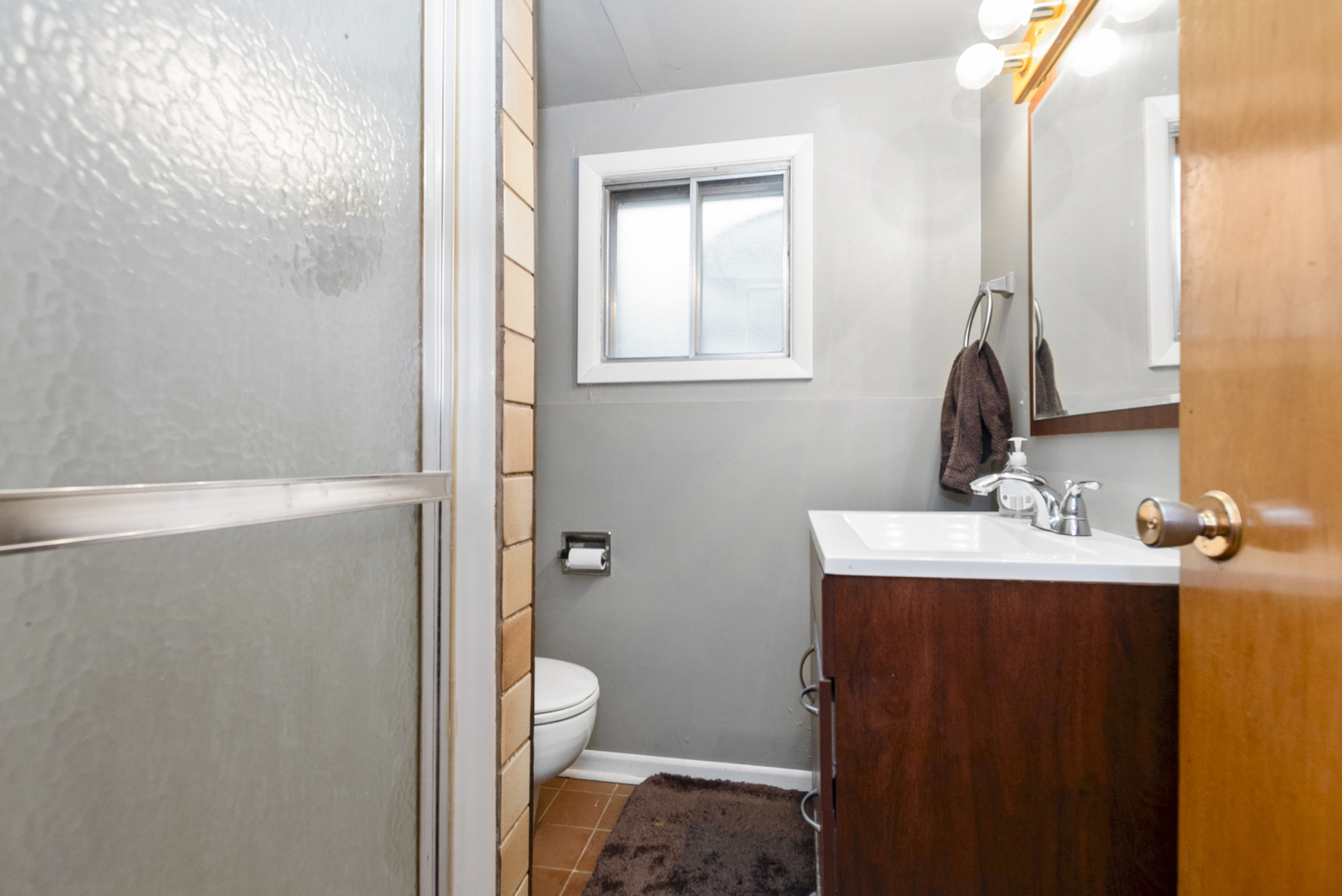 4511 West Howdy Lane Alsip, IL 60803 - Photo 16 of 17 a bathroom with a sink a toilet and shower