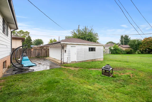 a view of a backyard with plants and a table