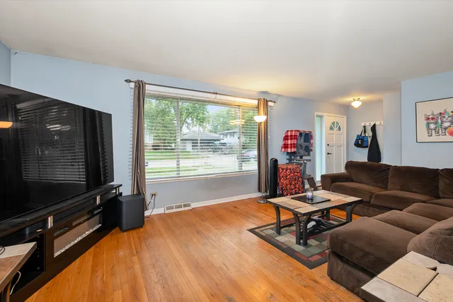 a living room with furniture gym equipment and a flat screen tv