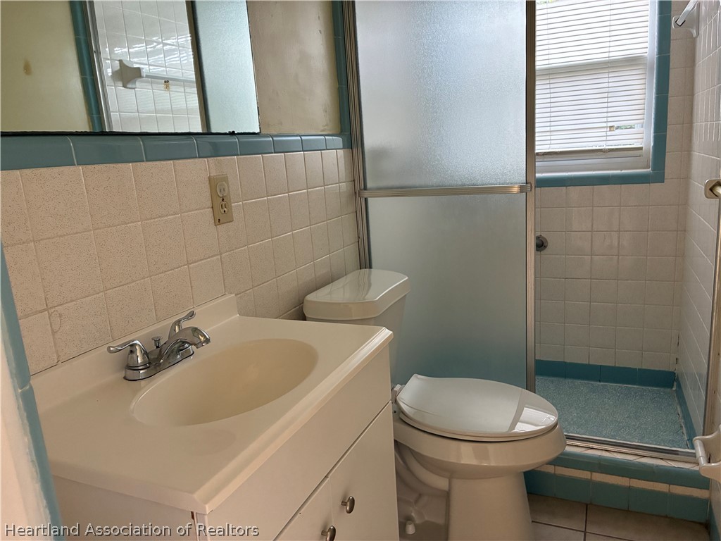 1525 Lagrange Avenue Sebring, FL 33870 - Photo 12 of 16 a bathroom with a sink a toilet and shower