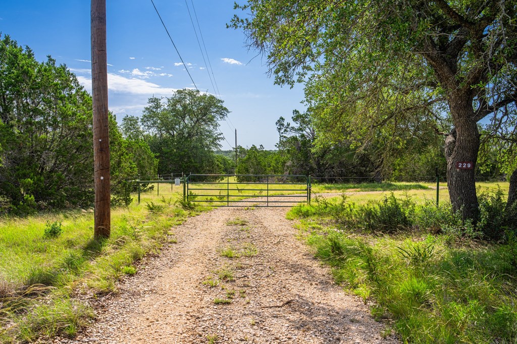 229 Lost Man Road Northwest Junction, TX 76849 - Photo 27 of 32 a view of a swimming pool and a yard