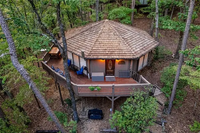 an aerial view of a house with a yard balcony and furniture