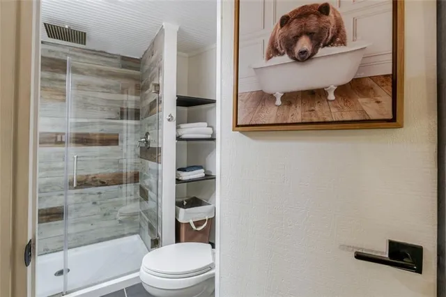 a bathroom with a toilet and a shower curtain