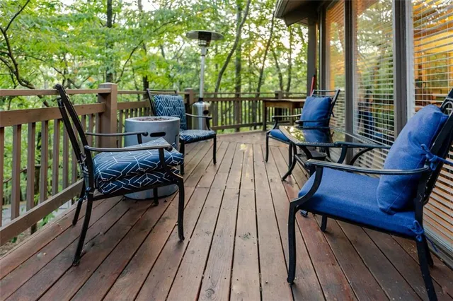 a view of a balcony with chairs and wooden floor