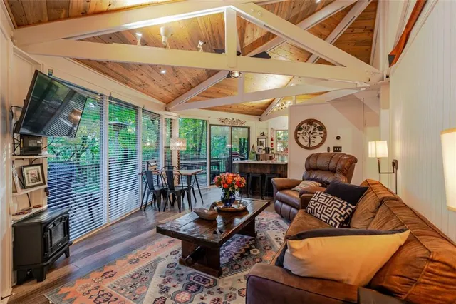 a living room with furniture a fireplace and a floor to ceiling window