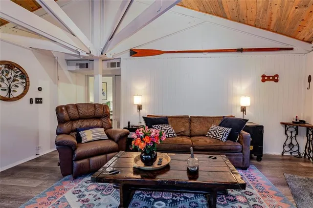 a living room with furniture a rug and a chandelier