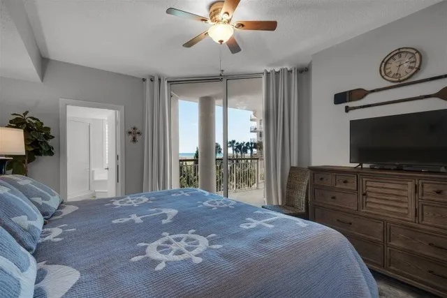 a bedroom with a bed and a flat tv screen on dresser