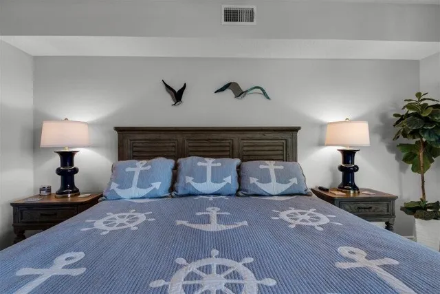 a bedroom with a bed and a night stand