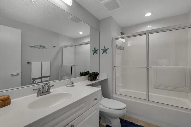 a bathroom with a sink toilet a mirror and shower