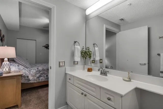 a en suite bathroom with a sink and a mirror