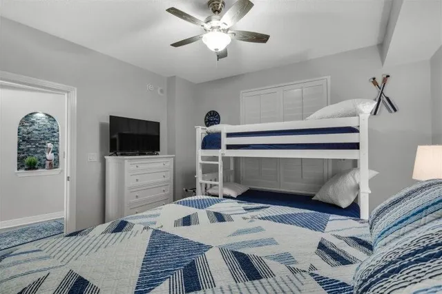 a bedroom with a bed and a flat screen tv