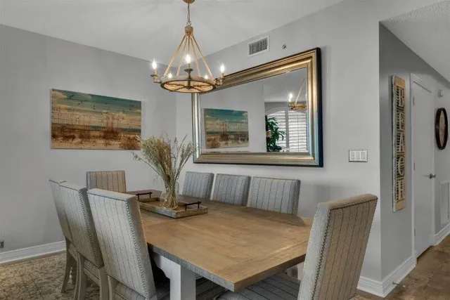 a view of a dining room with furniture and chandelier