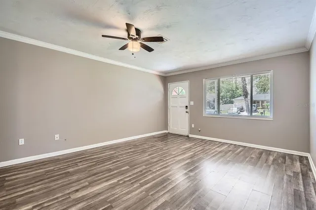 wooden floor in an empty room with a window