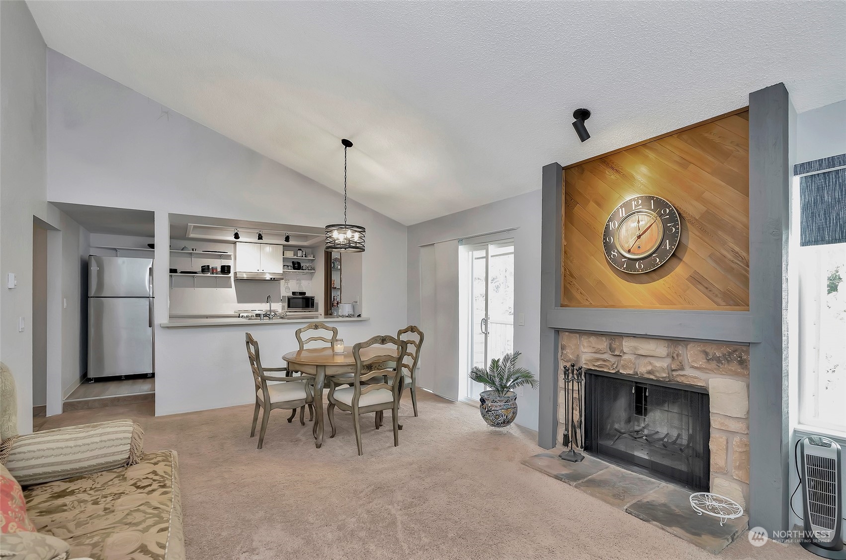 14401 Southeast Petrovitsky Road, Unit E205 Renton, WA 98058 - Photo 11 of 28 a dining room with furniture and a fireplace