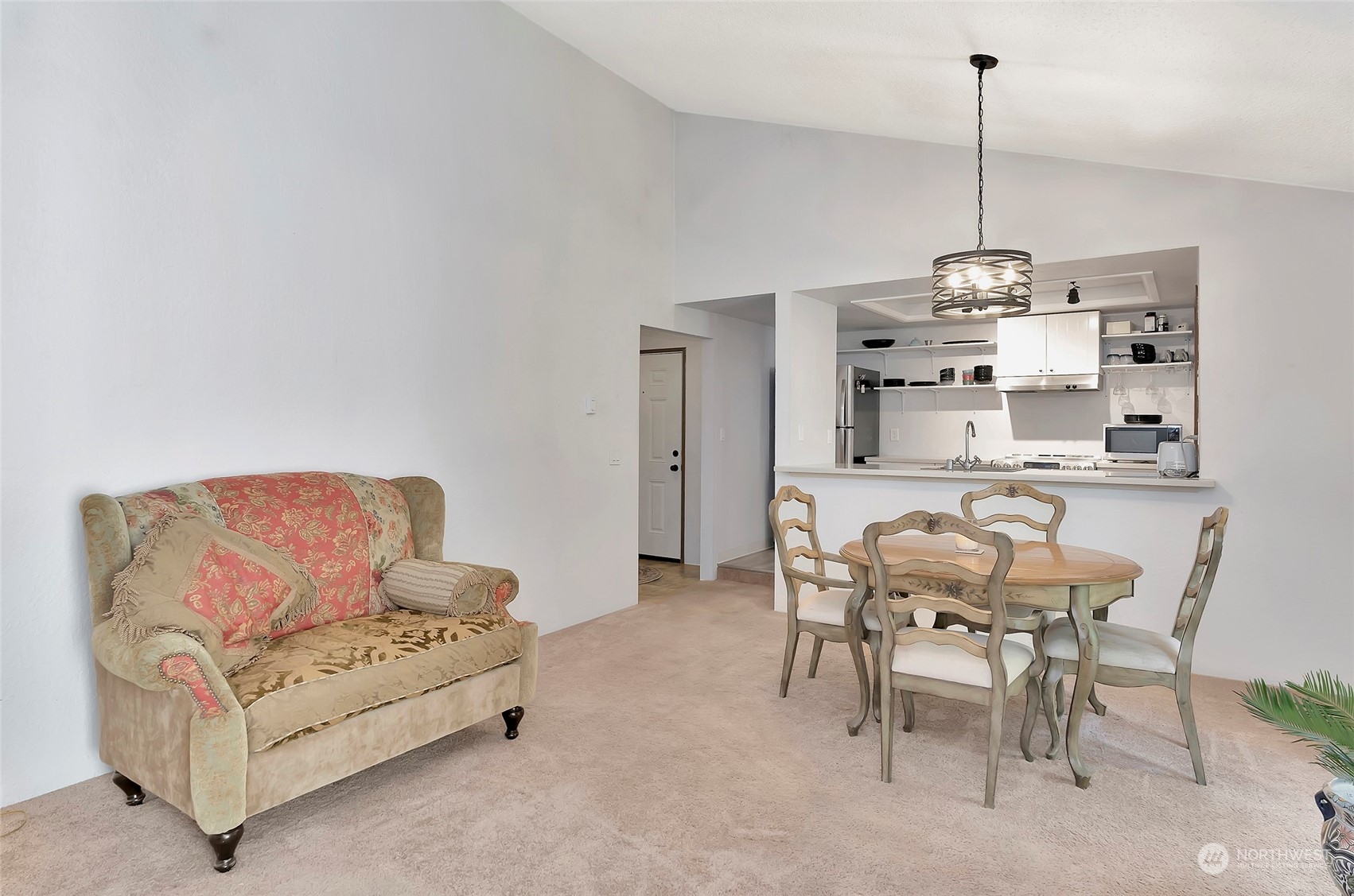 14401 Southeast Petrovitsky Road, Unit E205 Renton, WA 98058 - Photo 12 of 28 a living room with furniture and a chandelier