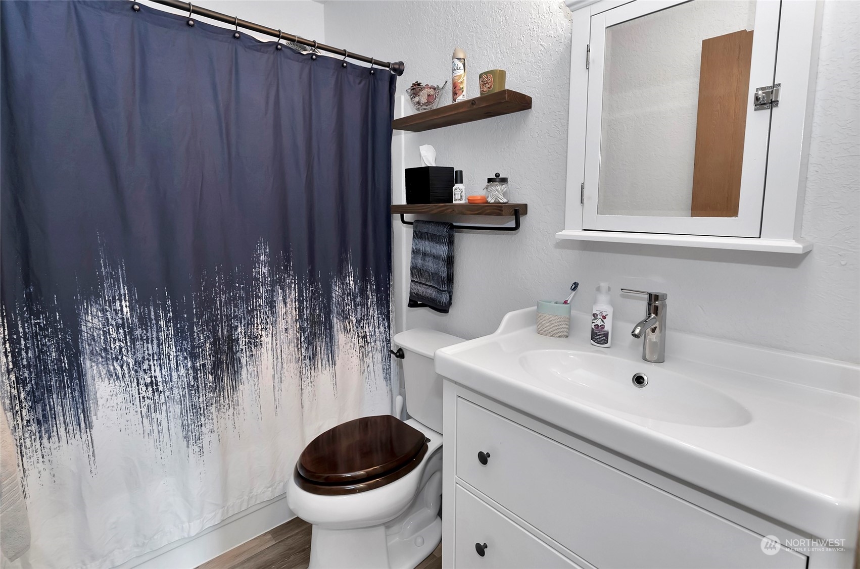 14401 Southeast Petrovitsky Road, Unit E205 Renton, WA 98058 - Photo 14 of 28 a bathroom with a sink and a toilet