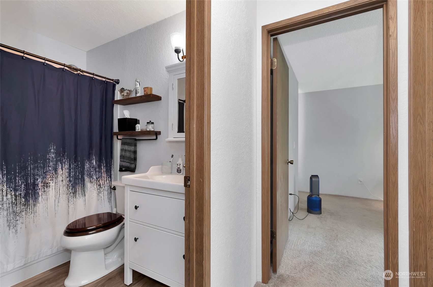 14401 Southeast Petrovitsky Road, Unit E205 Renton, WA 98058 - Photo 15 of 28 a bathroom with a sink toilet and shower