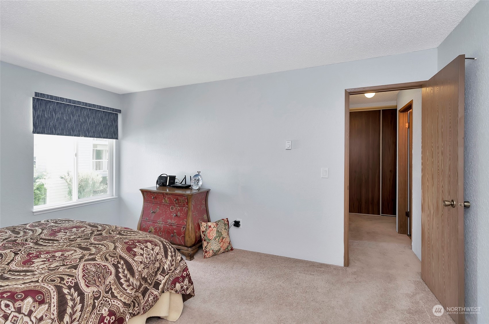 14401 Southeast Petrovitsky Road, Unit E205 Renton, WA 98058 - Photo 17 of 28 a bedroom with a bed and a window