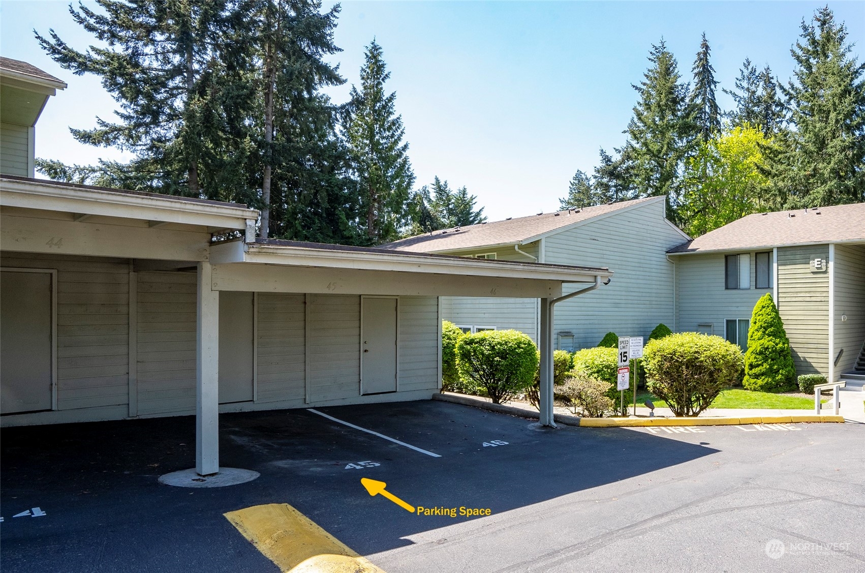 14401 Southeast Petrovitsky Road, Unit E205 Renton, WA 98058 - Photo 2 of 28 a front view of house with yard and trees in the background