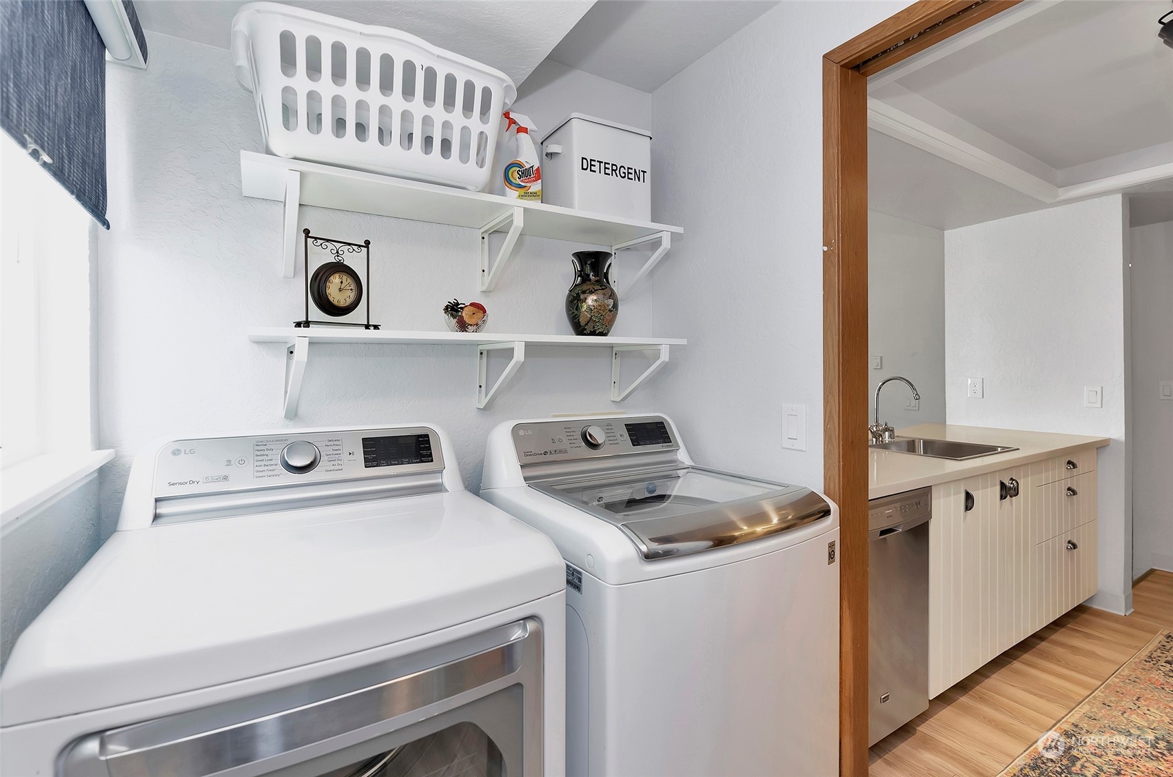 14401 Southeast Petrovitsky Road, Unit E205 Renton, WA 98058 - Photo 21 of 28 a kitchen with cabinets a stove and wooden floor