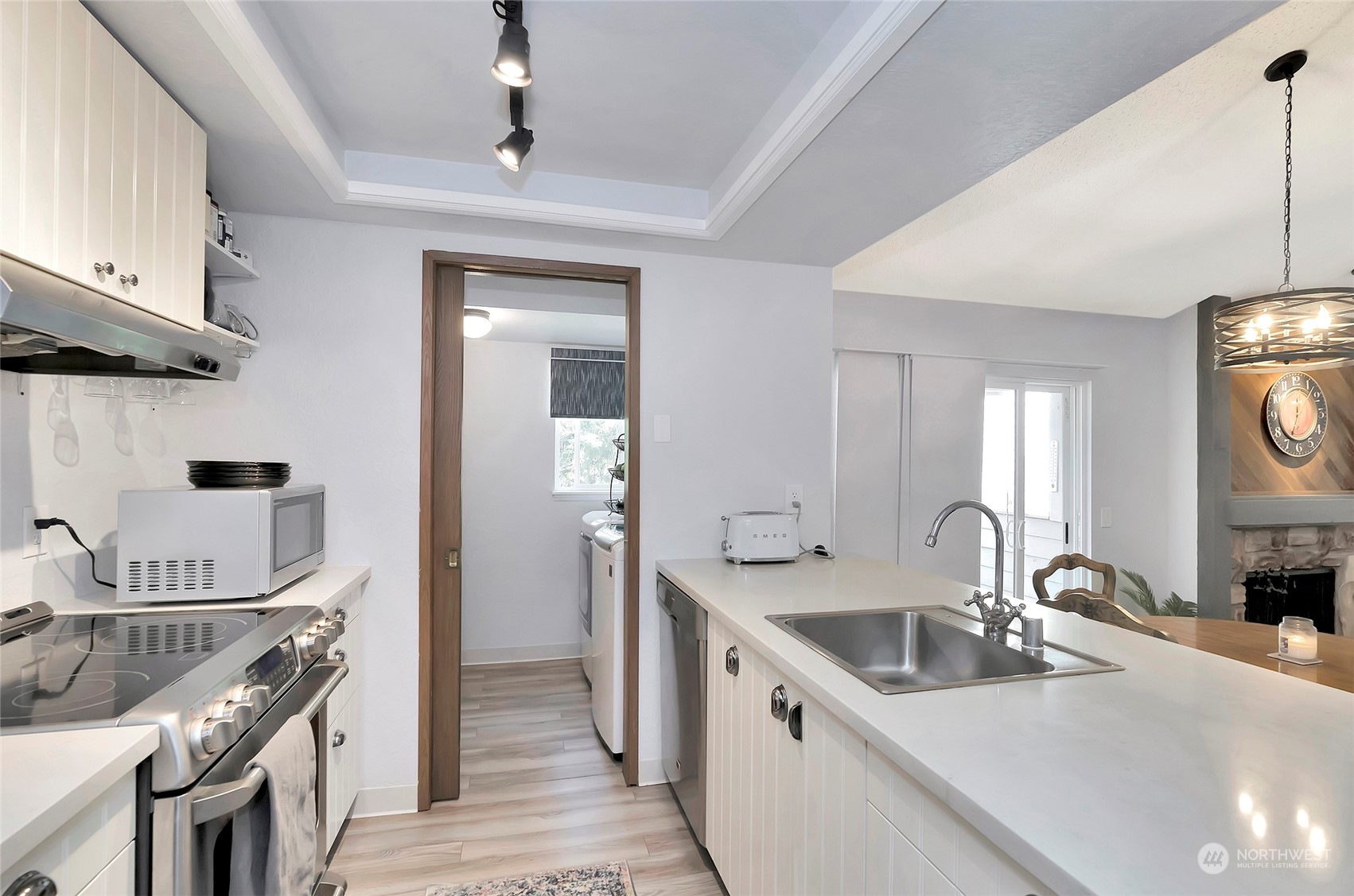 14401 Southeast Petrovitsky Road, Unit E205 Renton, WA 98058 - Photo 5 of 28 a kitchen with a sink stove top oven and cabinets