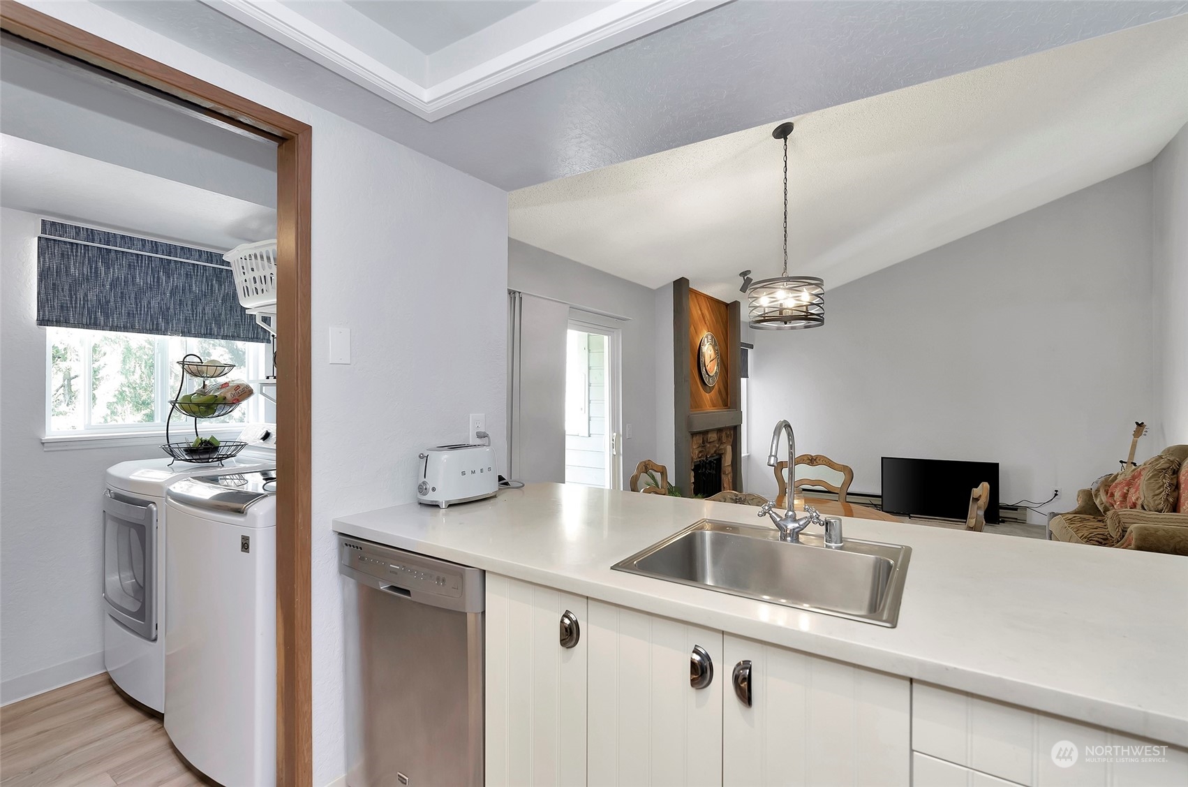 14401 Southeast Petrovitsky Road, Unit E205 Renton, WA 98058 - Photo 7 of 28 a kitchen with a sink and a refrigerator