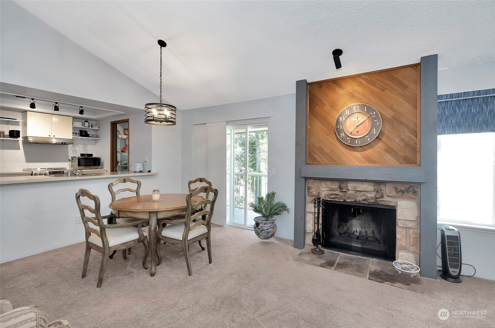 14401 Southeast Petrovitsky Road, Unit E205 Renton, WA 98058 - Photo 9 of 28 a dining room with furniture and a fireplace