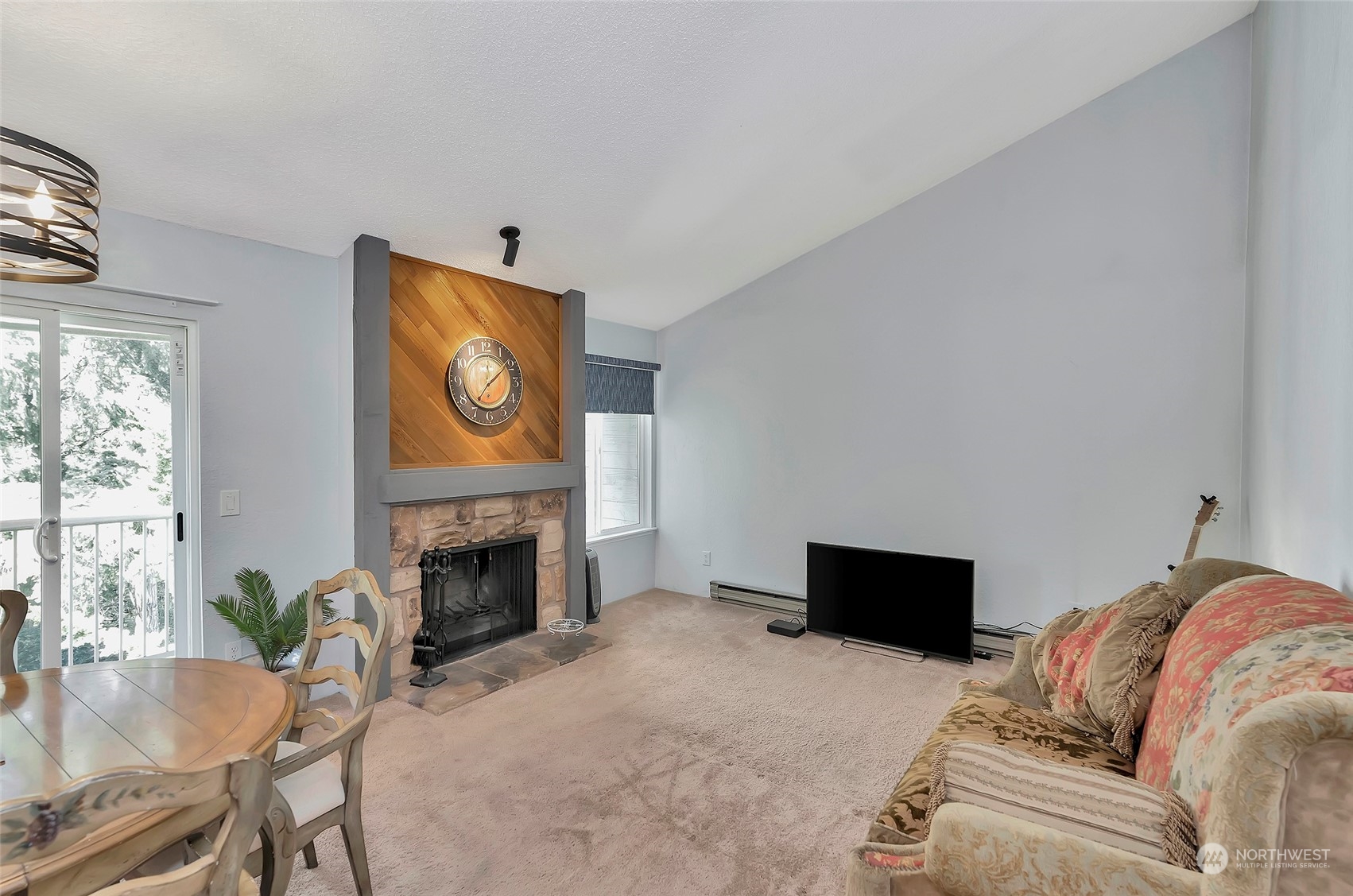 14401 Southeast Petrovitsky Road, Unit E205 Renton, WA 98058 - Photo 10 of 28 a living room with furniture and a fireplace