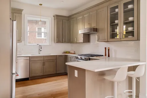 a kitchen with a stove a sink and a refrigerator