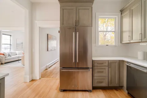 a kitchen with a refrigerator and a sink