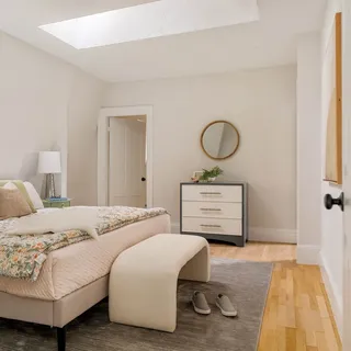 a bedroom with a bed and cabinets