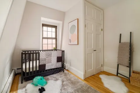 a bedroom with a bed and a potted plant