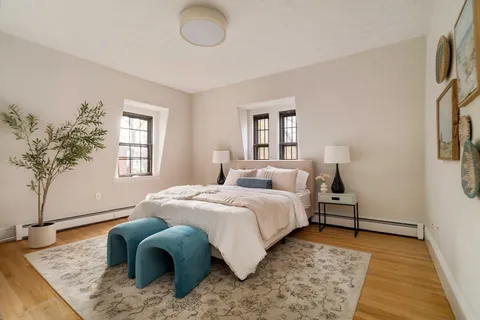 a bedroom with a bed and a window