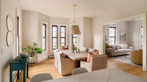 a living room with furniture potted plant and a window