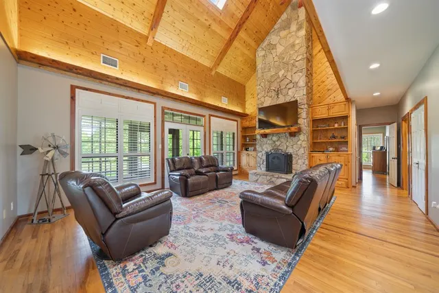 a living room with fireplace furniture and a wooden floor