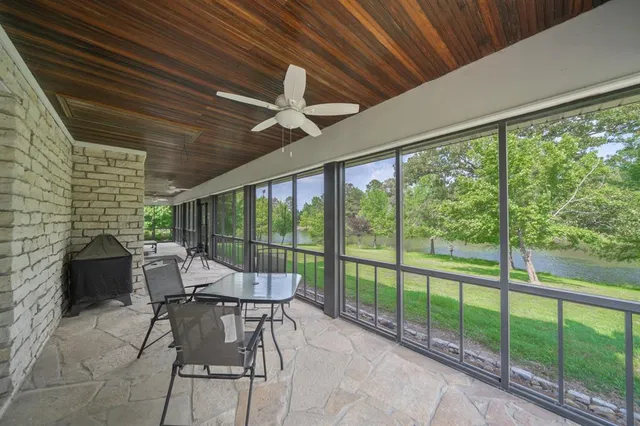 a living room with furniture and a floor to ceiling window