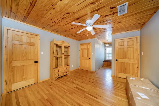 a view of hallway with wooden floor