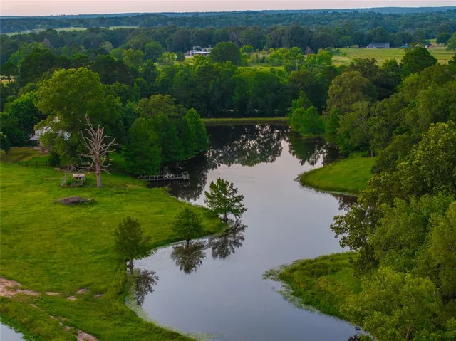 an aerial view of a house with yard