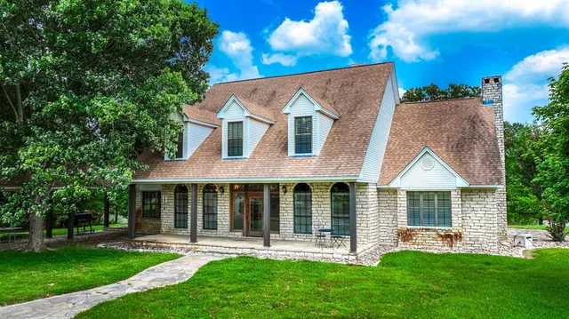 a front view of a house with a yard table and chairs