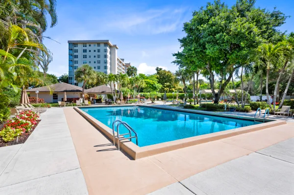 a view of swimming pool with outdoor seating and plants