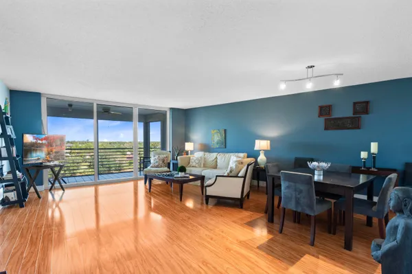 a living room with furniture and a floor to ceiling window