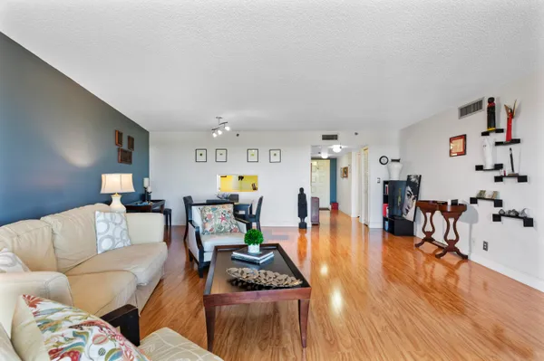 a living room with furniture and wooden floor