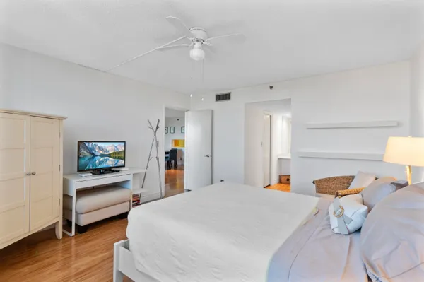 a bed room with bed and a chandelier