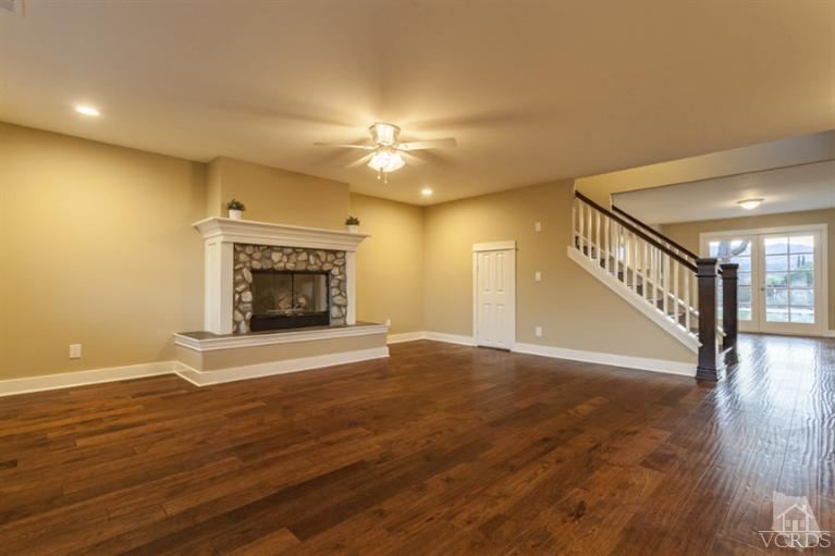 25029 Wheeler Road Newhall, CA 91321 - Photo 5 of 33 a view of an empty room with wooden floor fireplace and a window
