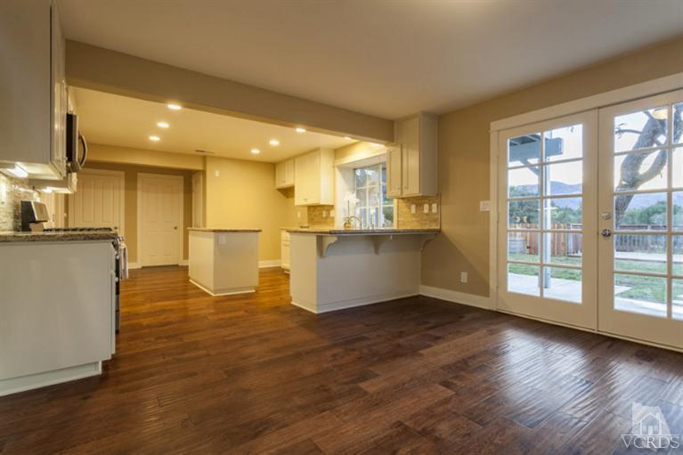 25029 Wheeler Road Newhall, CA 91321 - Photo 7 of 33 a view of a kitchen with kitchen island wooden floors and stainless steel appliances