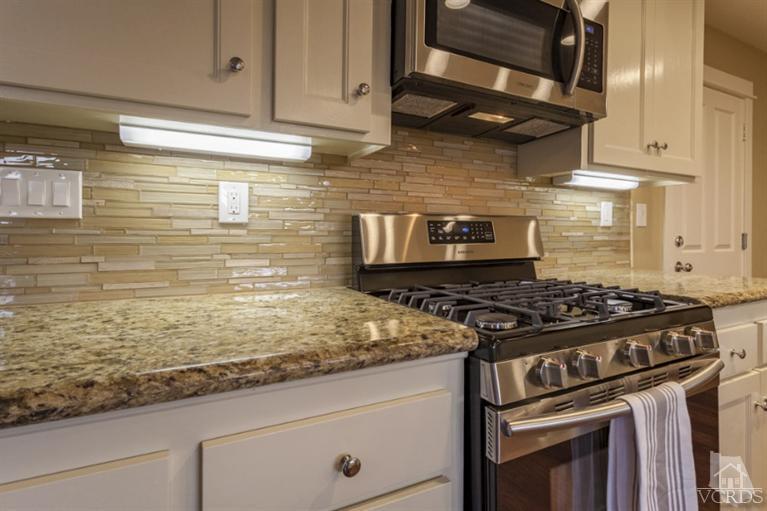 25029 Wheeler Road Newhall, CA 91321 - Photo 9 of 33 a stove top oven sitting inside of a kitchen