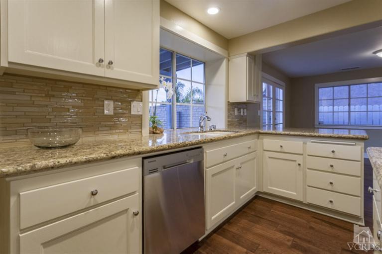 25029 Wheeler Road Newhall, CA 91321 - Photo 10 of 33 a kitchen with granite countertop white cabinets white appliances and a sink